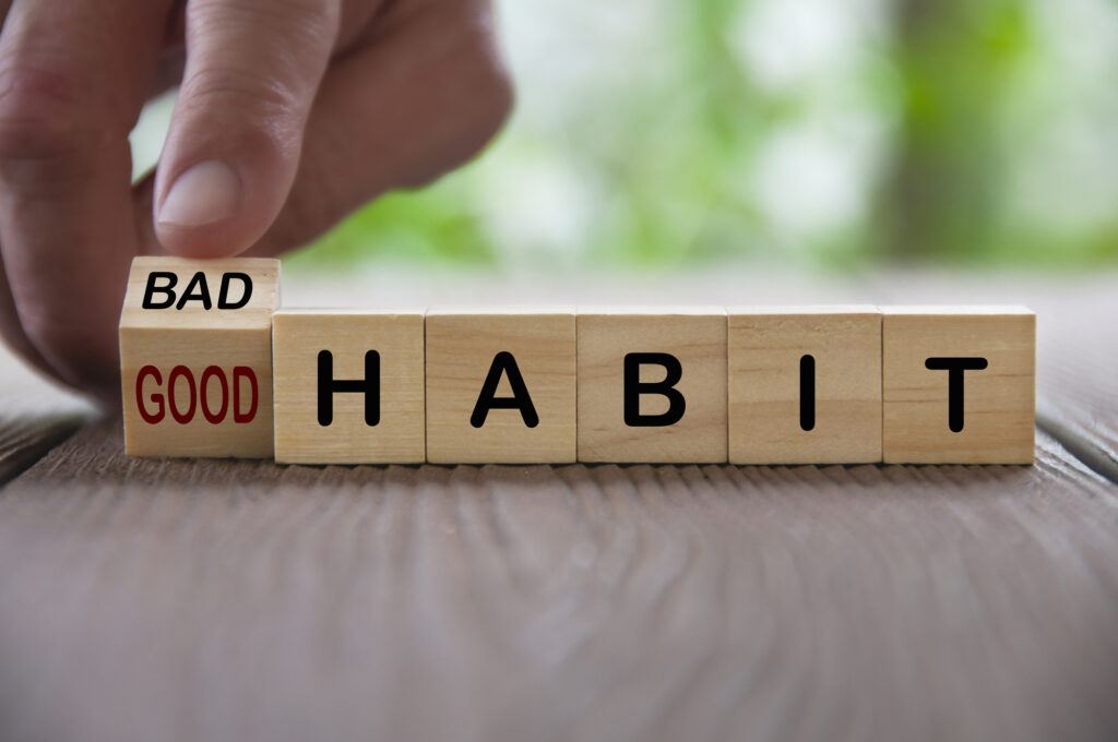 Finger turning bad and good text on wooden blocks. Good and bad habit concept.