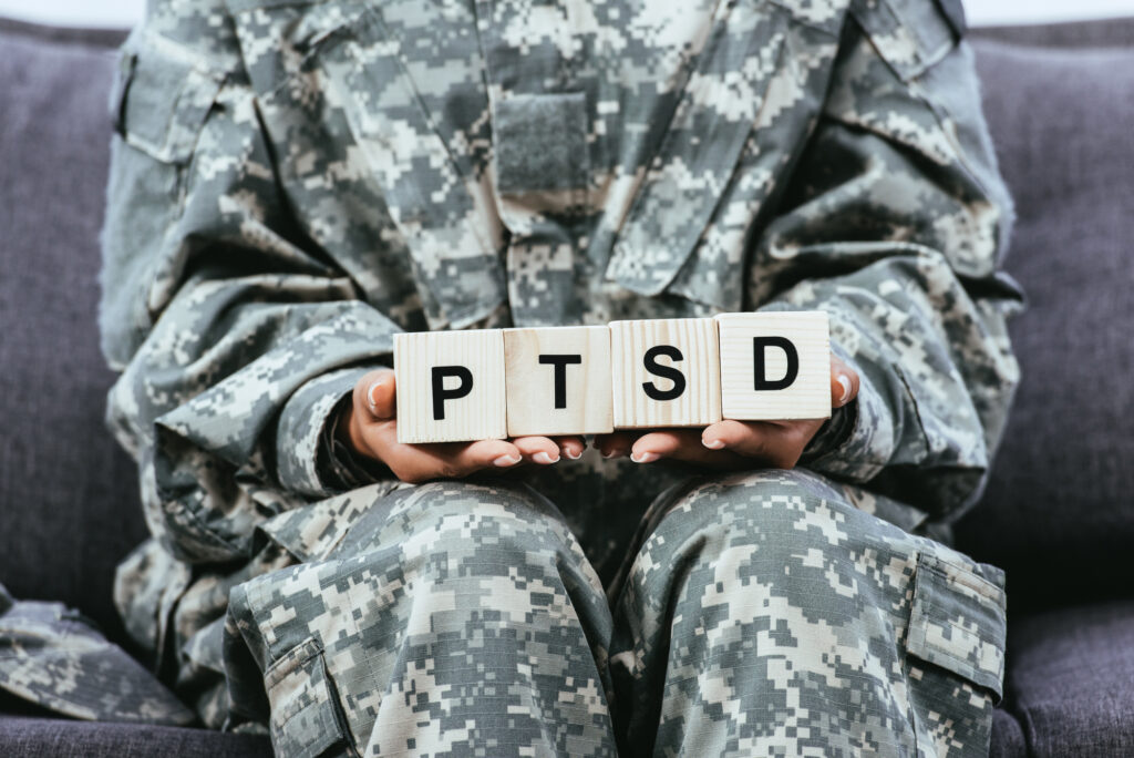 soldier holding PTSD letter blocks